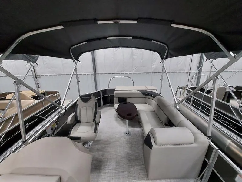 Slide: The Image of 2023 South Bay 220CR LE 25" pontoon boat interior with seating and canopy. - 9