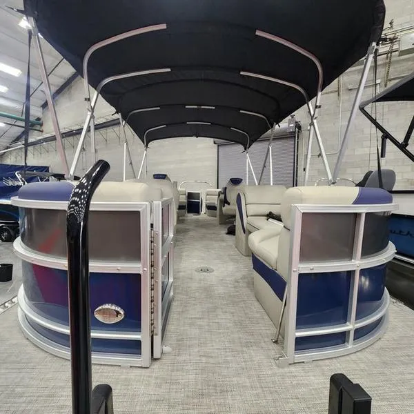 Slide: The Image of 2023 South Bay 224RS LE pontoon boat interior with canopy in showroom. - 12