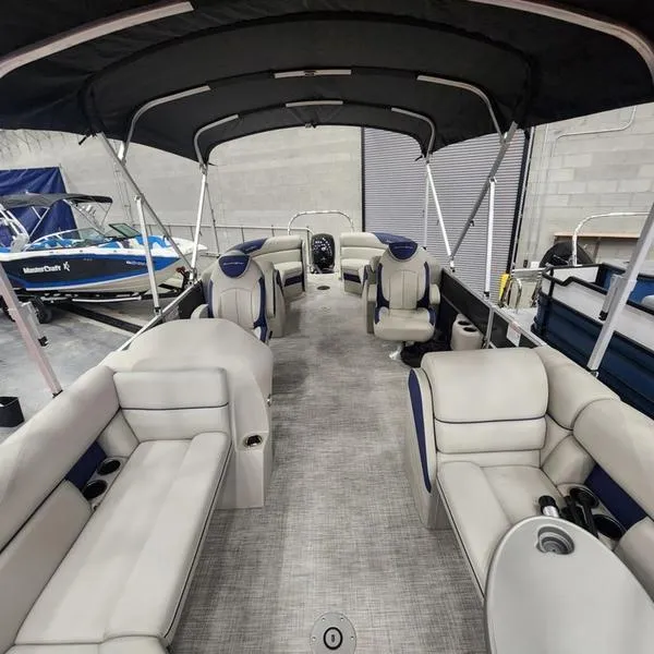 Slide: The Image of 2023 South Bay 224RS LE 25" pontoon boat interior with seating and canopy. - 16