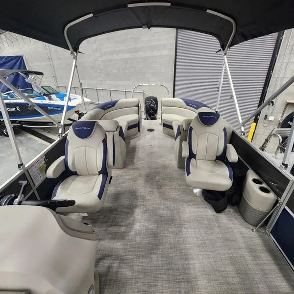 Slide: The Image of 2023 South Bay 224RS LE pontoon boat interior with plush seating and canopy. - 17