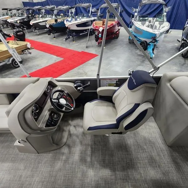 Slide: The Image of 2023 South Bay 224RS LE boat interior with captain's chair and steering console. - 18