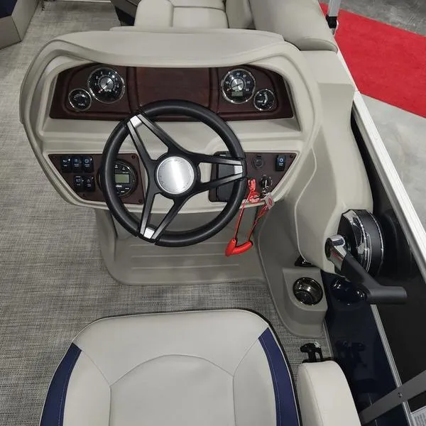 Slide: The Image of 2023 South Bay 224RS LE 25" boat helm with steering wheel and controls. - 19