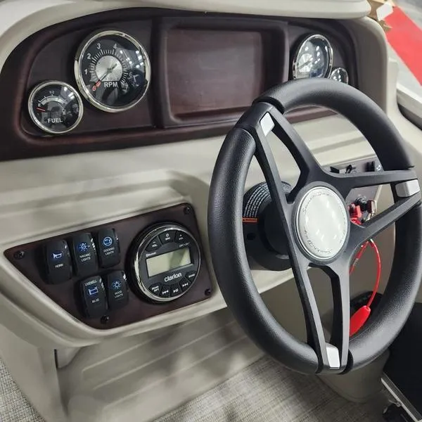Slide: The Image of 2023 South Bay 224RS LE 25" boat dashboard with steering wheel and gauges. - 20
