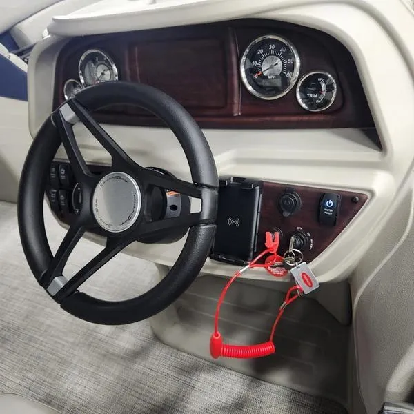 Slide: The Image of 2023 South Bay 224RS LE 25" boat dashboard with steering wheel and gauges. - 21
