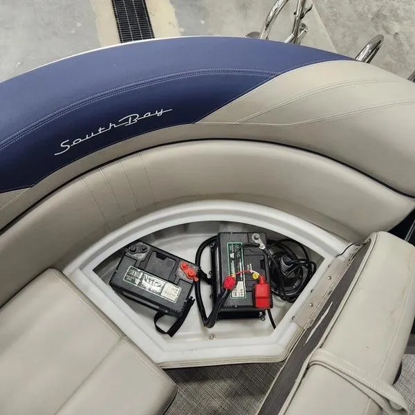 Slide: The Image of 2023 South Bay 224RS LE boat battery compartment with seating. - 23