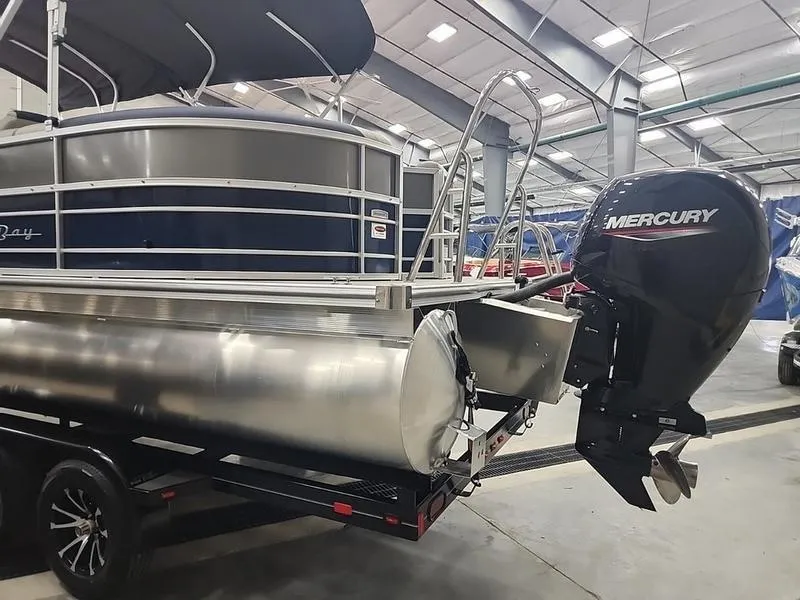 Slide: The Image of 2023 South Bay 224RS LE pontoon boat with Mercury outboard motor in showroom. - 5