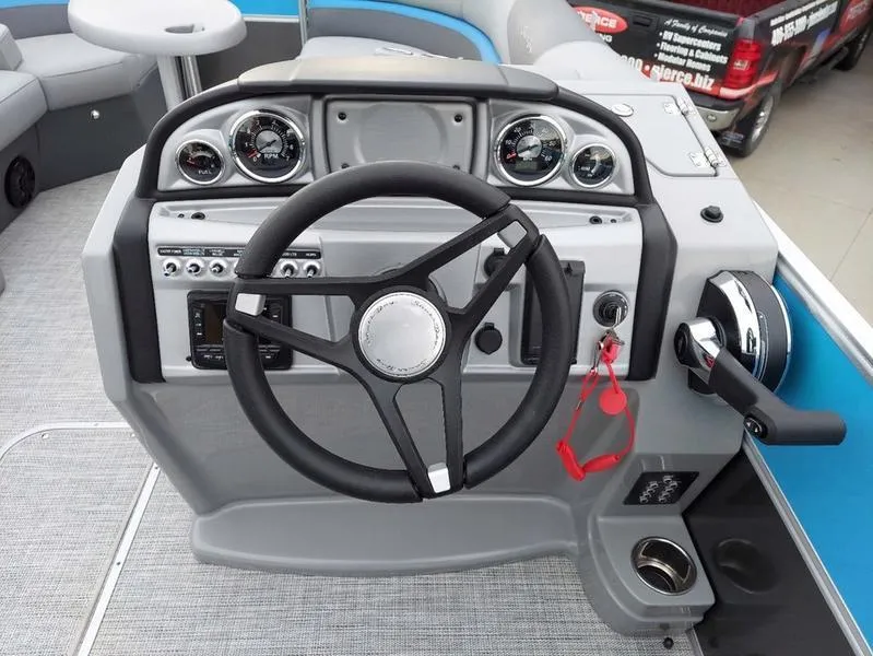 Slide: The Image of 2023 South Bay S224 UL 3.0 boat dashboard with steering wheel and controls. - 21