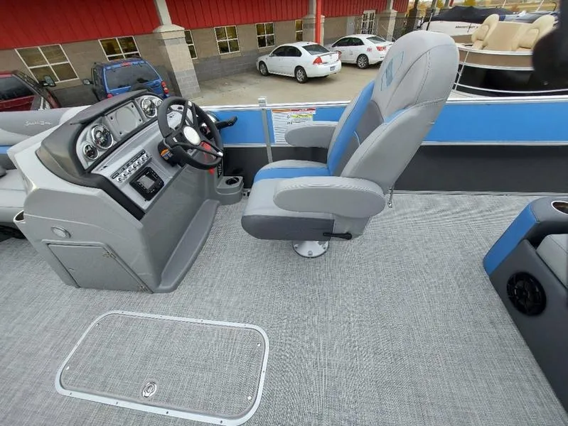 Slide: The Image of 2023 South Bay S224 UL 3.0 boat interior with steering console and captain's chair. - 22