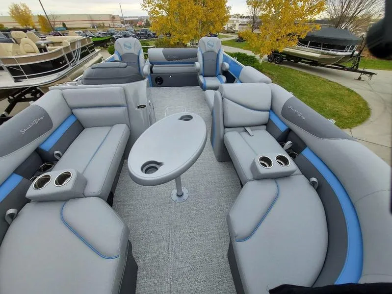 Slide: The Image of 2023 South Bay S224 UL 3.0 pontoon boat interior with plush seating and cup holders. - 26