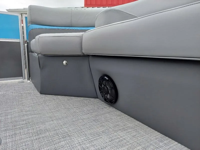 Slide: The Image of 2023 South Bay S224 UL 3.0 boat interior with gray seating and speaker detail. - 27
