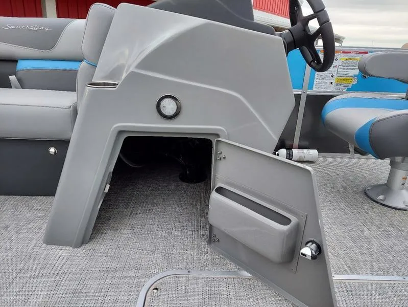 Slide: The Image of 2023 South Bay S224 UL 3.0 boat interior with open storage compartment and seating. - 28