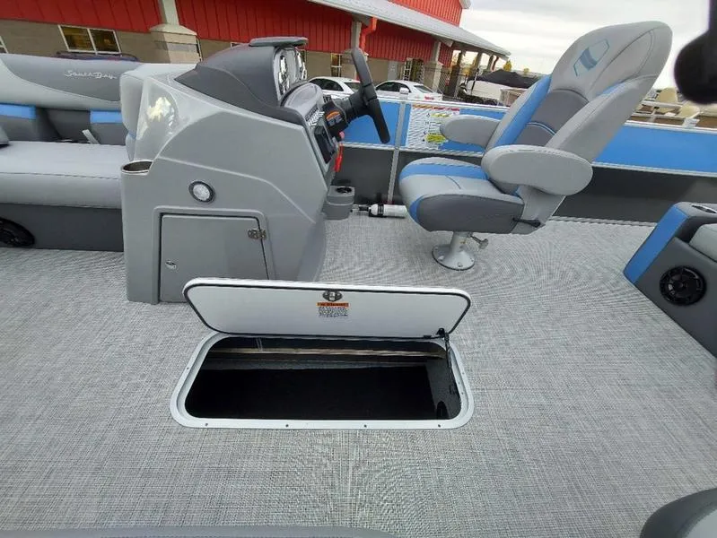 Slide: The Image of 2023 South Bay S224 UL 3.0 boat interior with open storage compartment. - 29