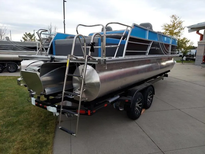 Slide: The Image of 2023 South Bay S224 UL 3.0 pontoon boat on trailer, parked outdoors. - 3