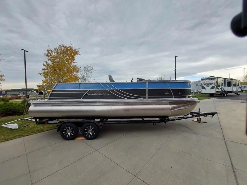 Slide: The Image of 2023 South Bay S224 UL 3.0 pontoon boat on trailer, parked outdoors. - 32