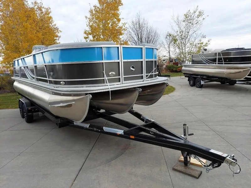 Slide: The Image of 2023 South Bay S224 UL 3.0 pontoon boat on trailer, parked outdoors. - 33