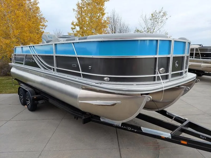 Slide: The Image of 2023 South Bay S224 UL 3.0 pontoon boat on trailer, parked outdoors. - 4