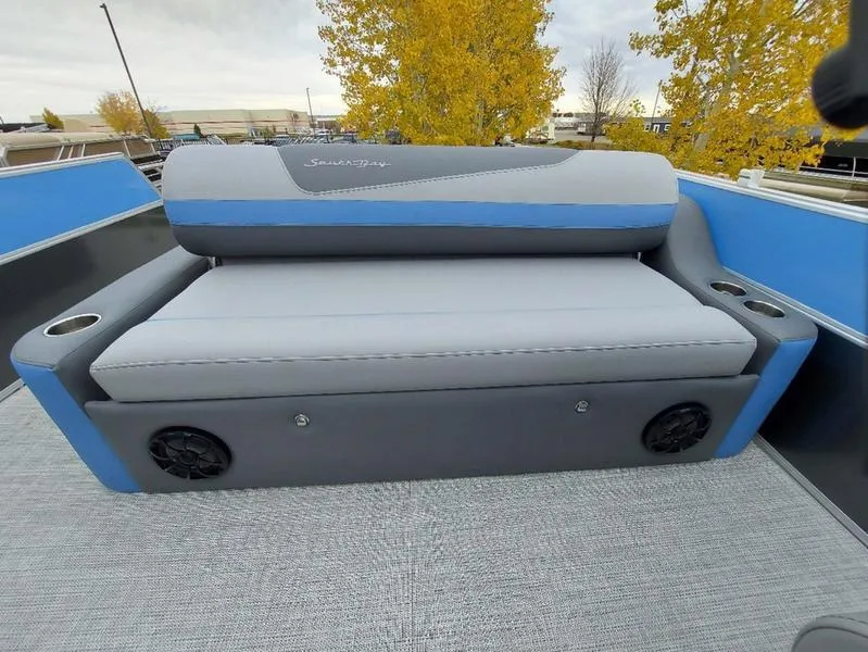 Slide: The Image of 2023 South Bay S224 UL 3.0 boat seat with gray and blue upholstery, cup holders, and speakers. - 9