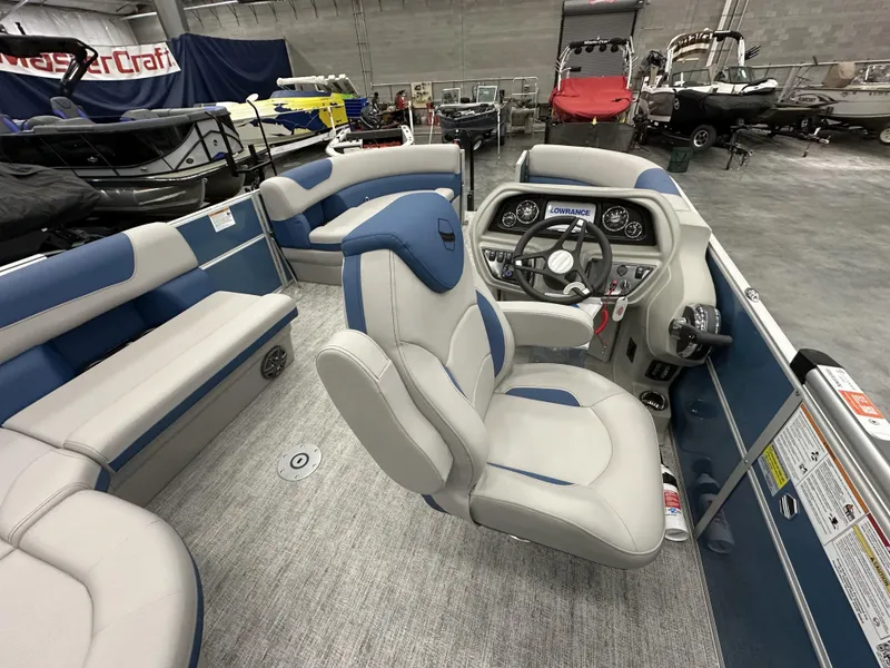 Slide: The Image of Interior of 2025 South Bay 222FCRLE pontoon boat with modern seating and control panel. - 12