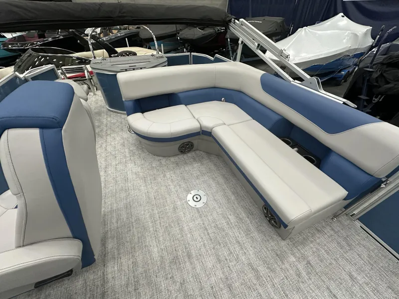 Slide: The Image of 2025 South Bay 222FCRLE pontoon boat interior with blue and gray seating. - 13
