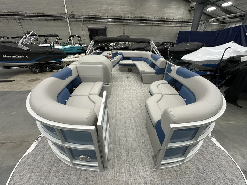 Slide: The Image of 2025 South Bay 222FCRLE pontoon boat with spacious seating in a showroom. - 7
