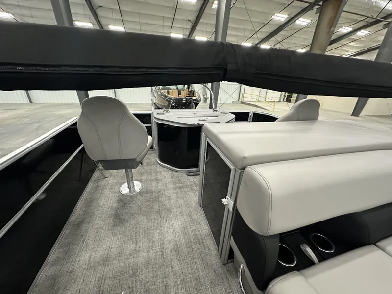 Slide: The Image of 2025 South Bay 224FCRLE pontoon boat interior with modern seating and helm. - 10