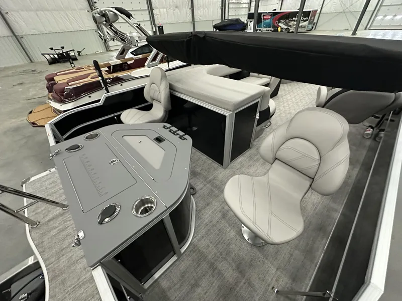 Slide: The Image of 2025 South Bay 224FCRLE pontoon boat interior with modern seating and control panel. - 11