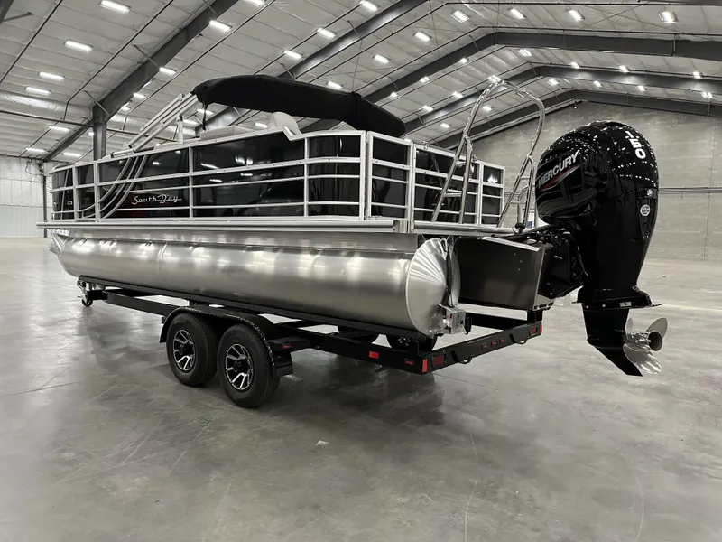 Slide: The Image of 2025 South Bay 224FCRLE pontoon boat in a spacious indoor facility. - 3