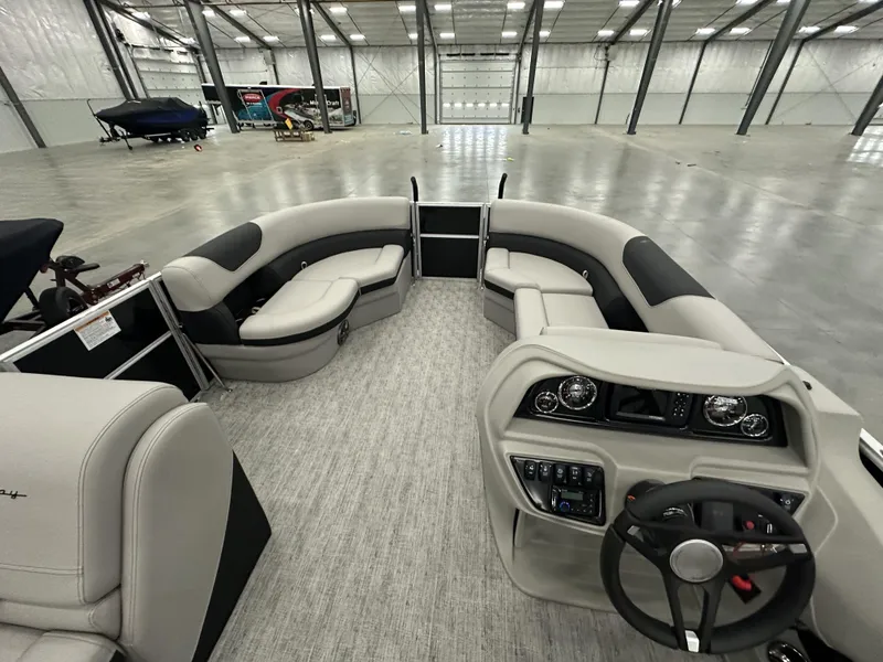 Slide: The Image of 2025 South Bay 224FCRLE pontoon boat interior with modern dashboard and spacious seating. - 7
