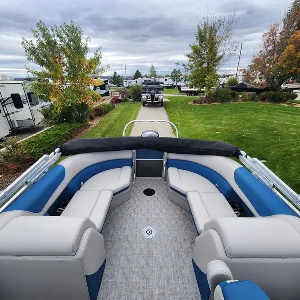 Slide: The Image of 2024 South Bay 222RS LE 2.75 pontoon boat with spacious seating, parked outdoors. - 13