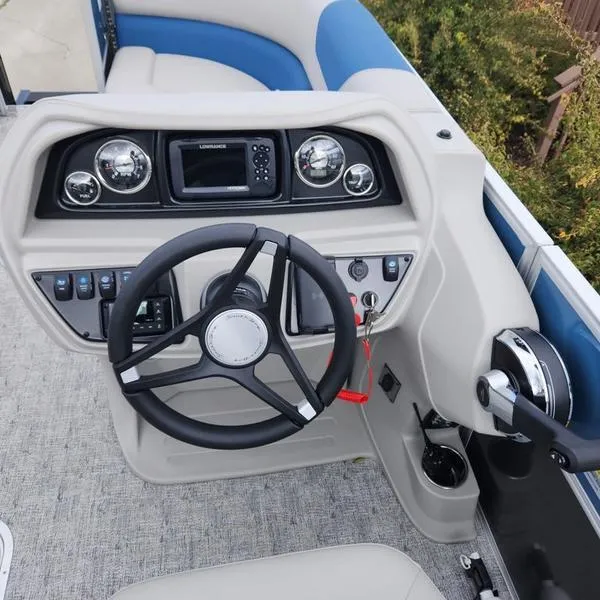 Slide: The Image of 2024 South Bay 222RS LE 2.75 boat dashboard with steering wheel and controls. - 19