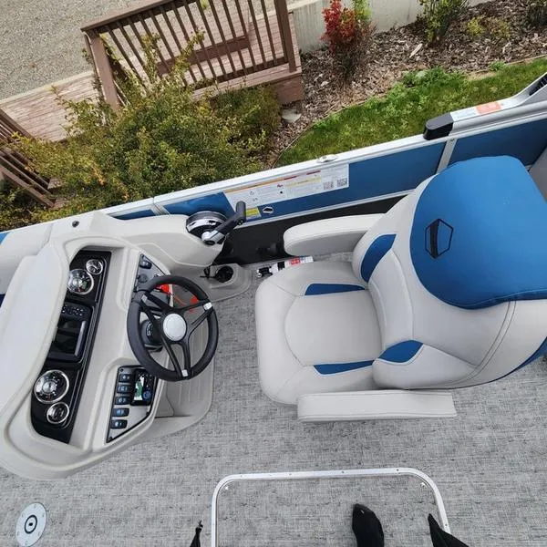 Slide: The Image of 2024 South Bay 222RS LE 2.75 boat interior with steering wheel and captain's chair. - 21