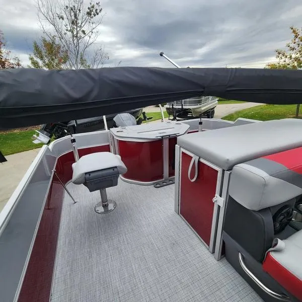 Slide: The Image of 2024 South Bay S224FCR 2.75 pontoon boat interior with red and gray seating. - 11