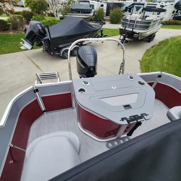 Slide: The Image of 2024 South Bay S224FCR 2.75 pontoon boat with Mercury outboard motor, docked on trailer. - 12