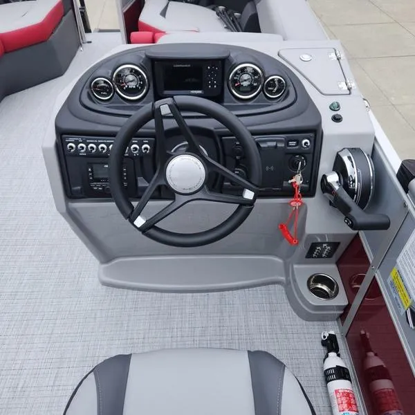 Slide: The Image of 2024 South Bay S224FCR 2.75 boat dashboard with steering wheel and controls. - 15