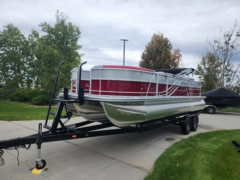 Slide: The Image of 2024 South Bay S224FCR 2.75 pontoon boat on trailer, parked on driveway. - 8