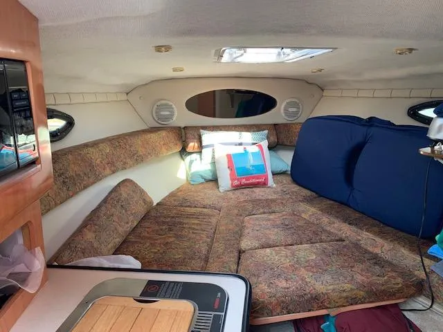 Slide: The Image of Interior of 1999 Regal 2850 LSC boat with cozy cabin seating. - 11