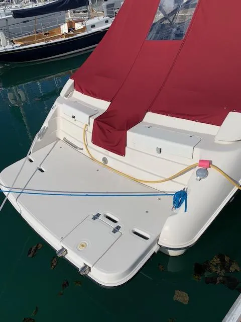 Slide: The Image of 1999 Regal 2850 LSC boat with red cover docked in marina. - 4