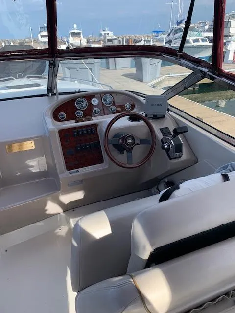 Slide: The Image of 1999 Regal 2850 LSC boat cockpit with steering wheel and control panel. - 5