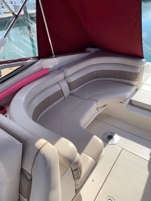 Slide: The Image of 1999 Regal 2850 LSC boat interior with beige seating and red canopy. - 7