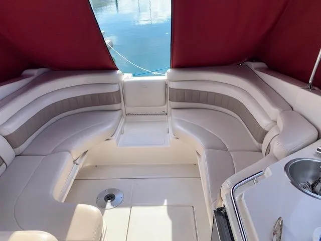 Slide: The Image of 1999 Regal 2850 LSC boat interior with beige seating and red canopy. - 8