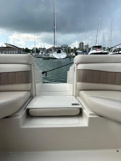 Slide: The Image of 1999 Regal 2850 LSC boat interior with marina view, cloudy sky. - 9