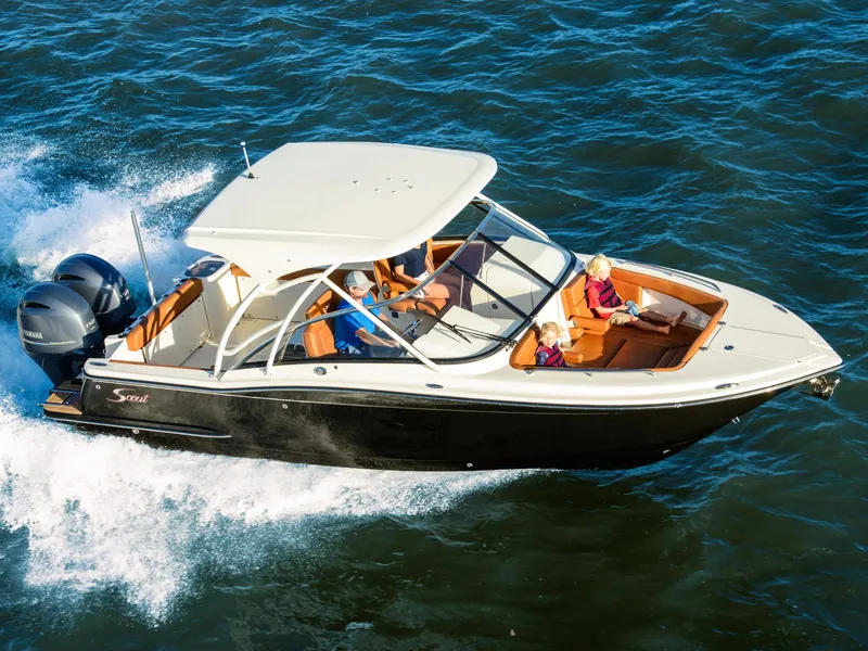 The Image of 2026 Scout 255 Dorado boat cruising on open water with passengers enjoying the ride. - 0