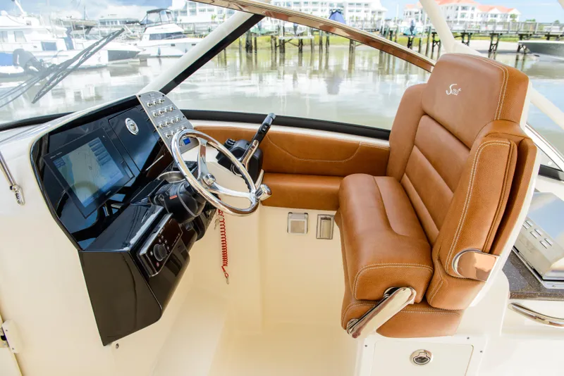 Slide: The Image of 2026 Scout 255 Dorado helm with leather seating and modern controls. - 13
