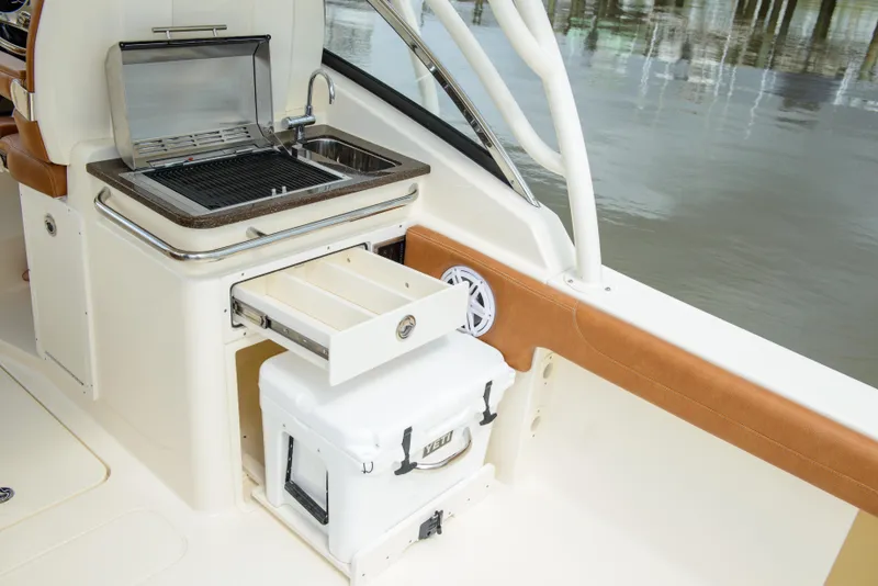 Slide: The Image of 2026 Scout 255 Dorado boat with grill, sink, and storage drawer. - 25