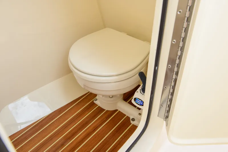 Slide: The Image of 2026 Scout 255 Dorado boat toilet with wooden flooring detail. - 31