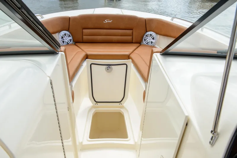 Slide: The Image of 2026 Scout 255 Dorado boat interior with tan seating and storage compartment. - 8