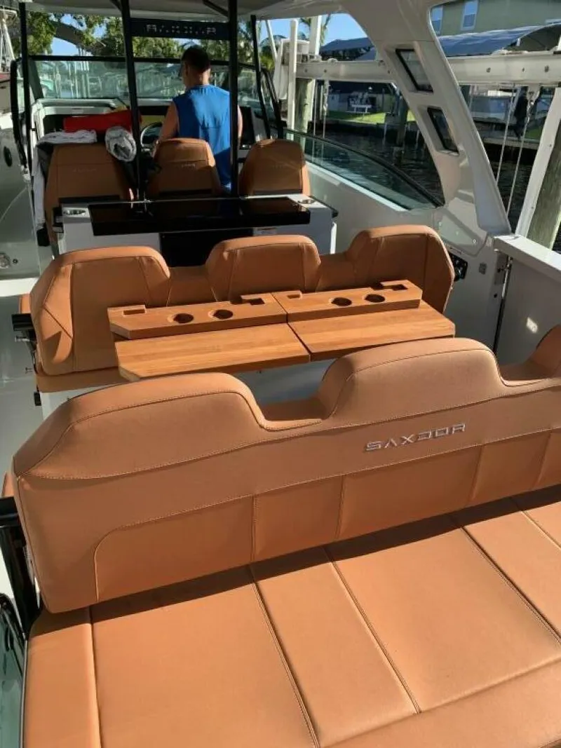 Slide: The Image of 2023 Saxdor 320 GTO boat interior with tan leather seats and modern design. - 18