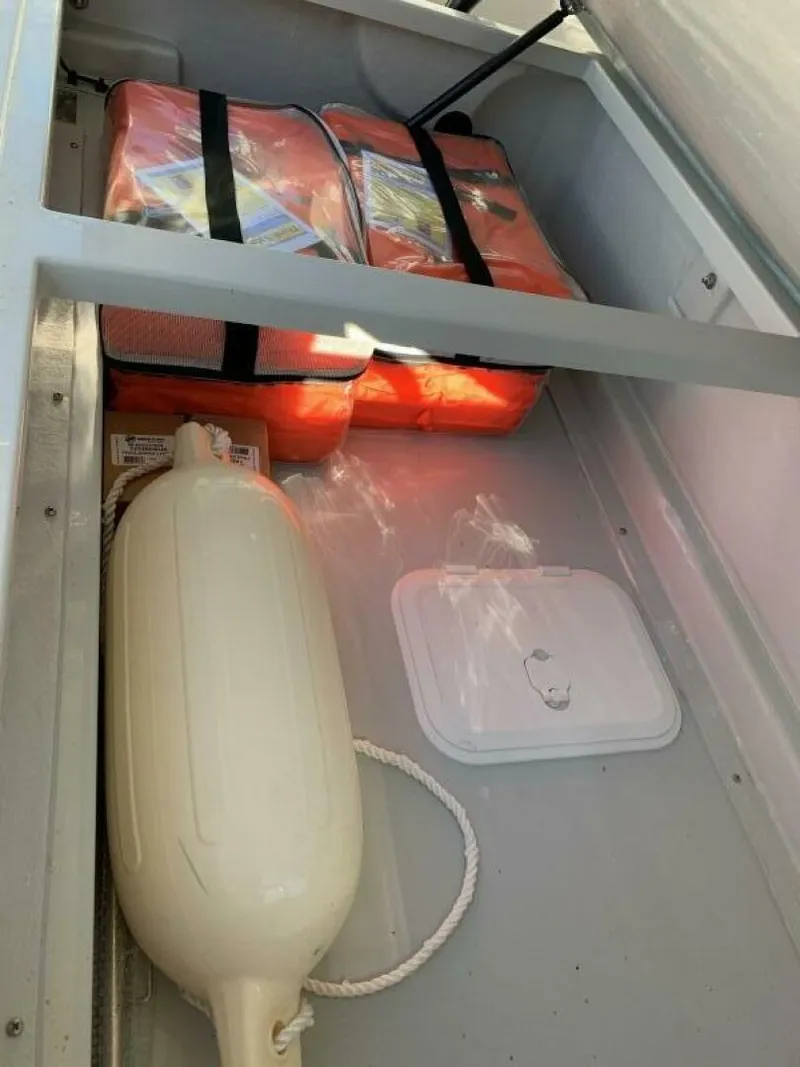 Slide: The Image of Storage compartment in 2023 Saxdor 320 GTO with life jackets and a fender. - 21
