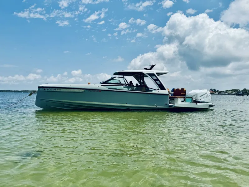 Slide: The Image of 2023 Saxdor 320 GTO boat on calm water under a partly cloudy sky. - 3