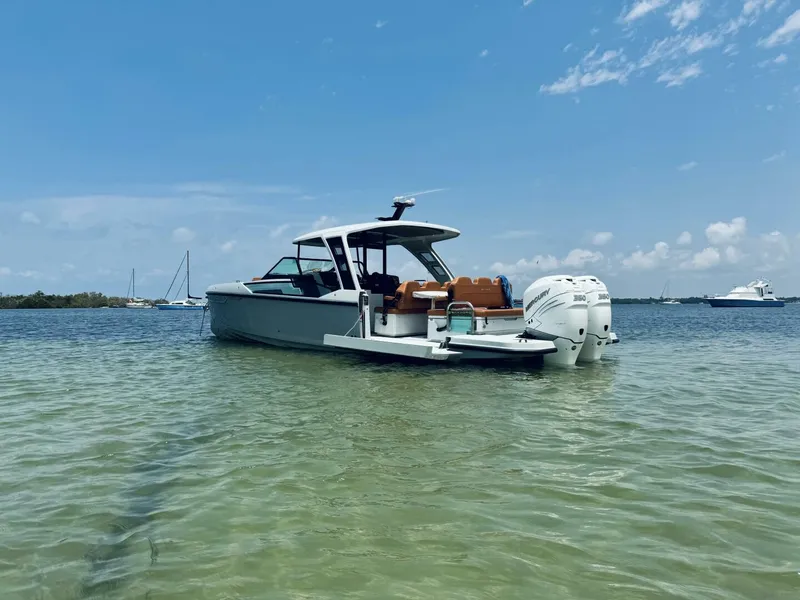 Slide: The Image of 2023 Saxdor 320 GTO boat in shallow water, clear sky background. - 4